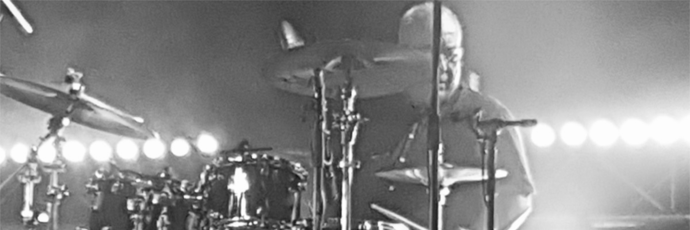 Alain Rieder playing drums on stage.